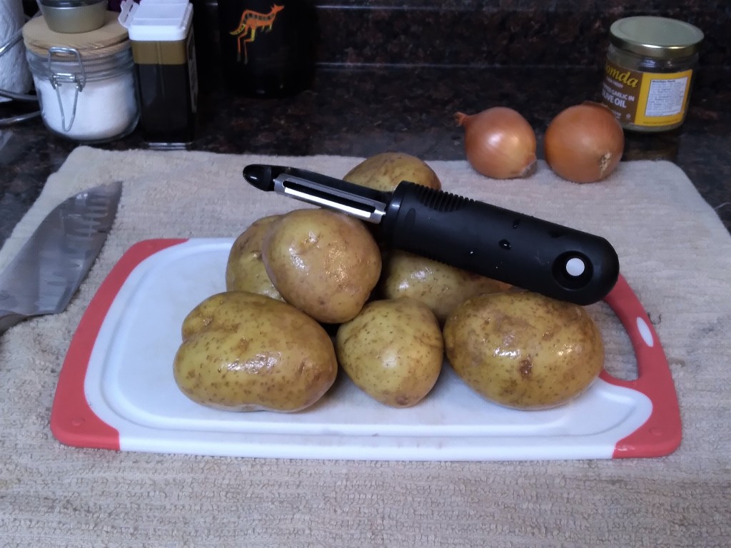 Start the Gotcha! pork roast recipe by peeling your potatoes